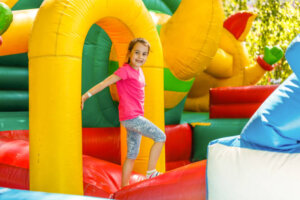 Joyful little girl playing on a trampoline