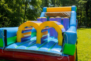 Part of a large color inflatable children attraction in the grass in the park