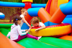 excited kids having fun on inflatable attraction playground